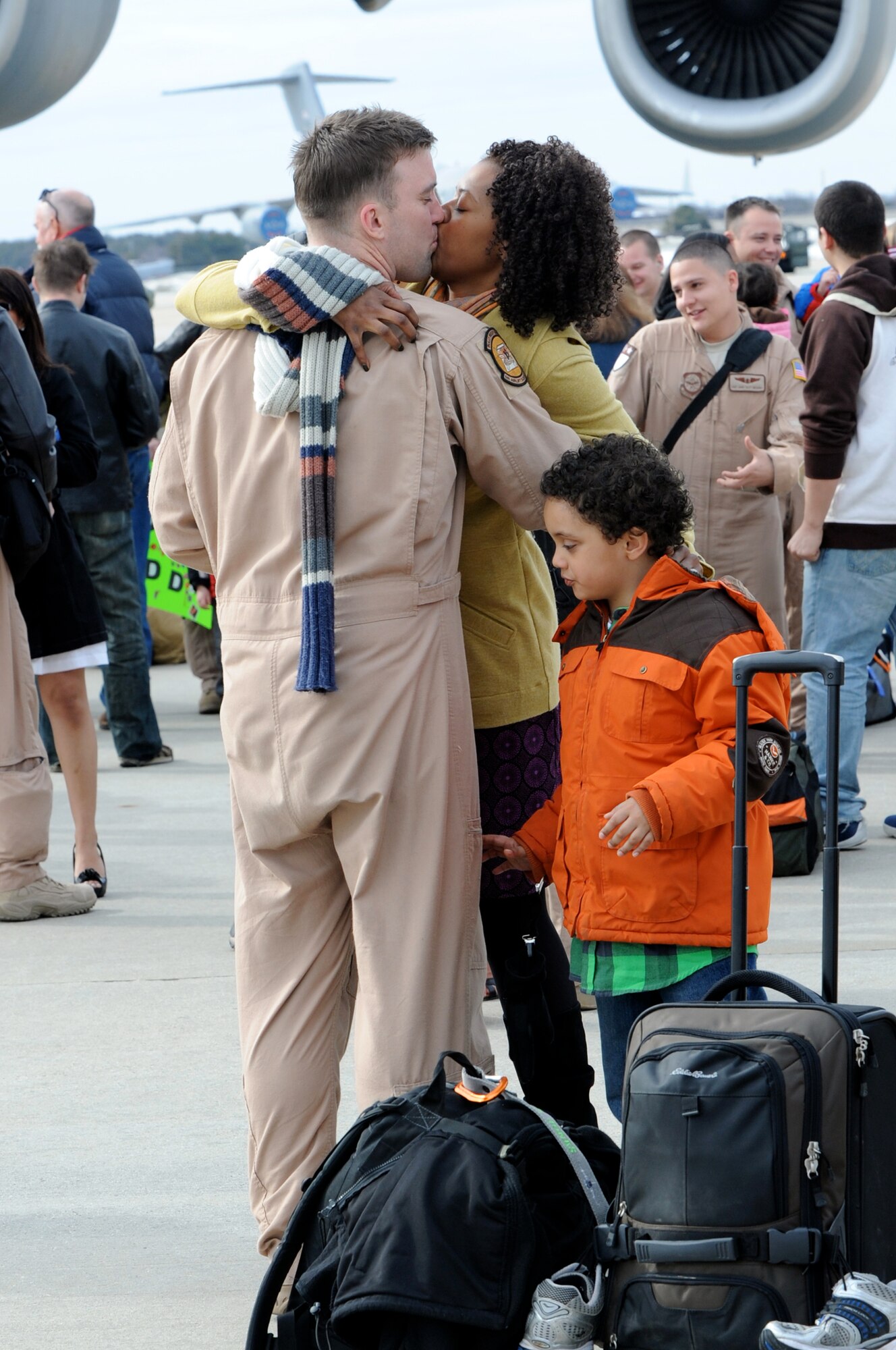 Staff Sgt. Donald Jones is greeted by his wife, Taccora Jones, and son, Caleb Jones, after arriving home March 2, 2010, at Joint Base McGuire-Dix-Lakehurst, N.J. The squadron assumed the role and mission of the 817th Expeditionary Airlift Squadron when they deployed in October 2009 in support of operations Iraqi Freedom and Enduring Freedom. Sergeant Jones is a 6th Airlift Squadron loadmaster. (U.S. Air Force photo/Wayne Russell)
