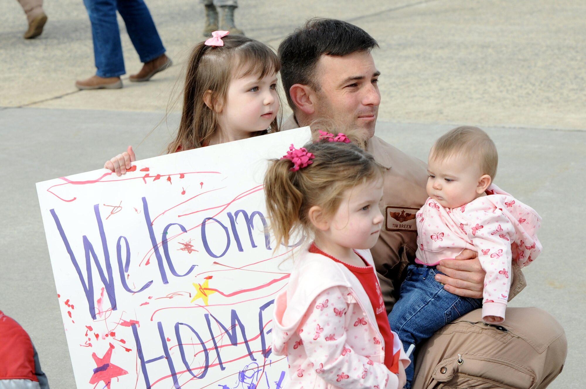 Maj. Tom Breen reunites with daughters Nicole (left to right), Audrey and Tori, after a four-month deployment in support of operations Iraqi Freedom and Enduring Freedom March 2, 2010, at Joint Base McGuire-Dix-Lakehurst, N.J. Major Breen is a 6th Airlift Squadron C-17 Globemaster III pilot. (U.S. Air Force photo/Wayne Russell)