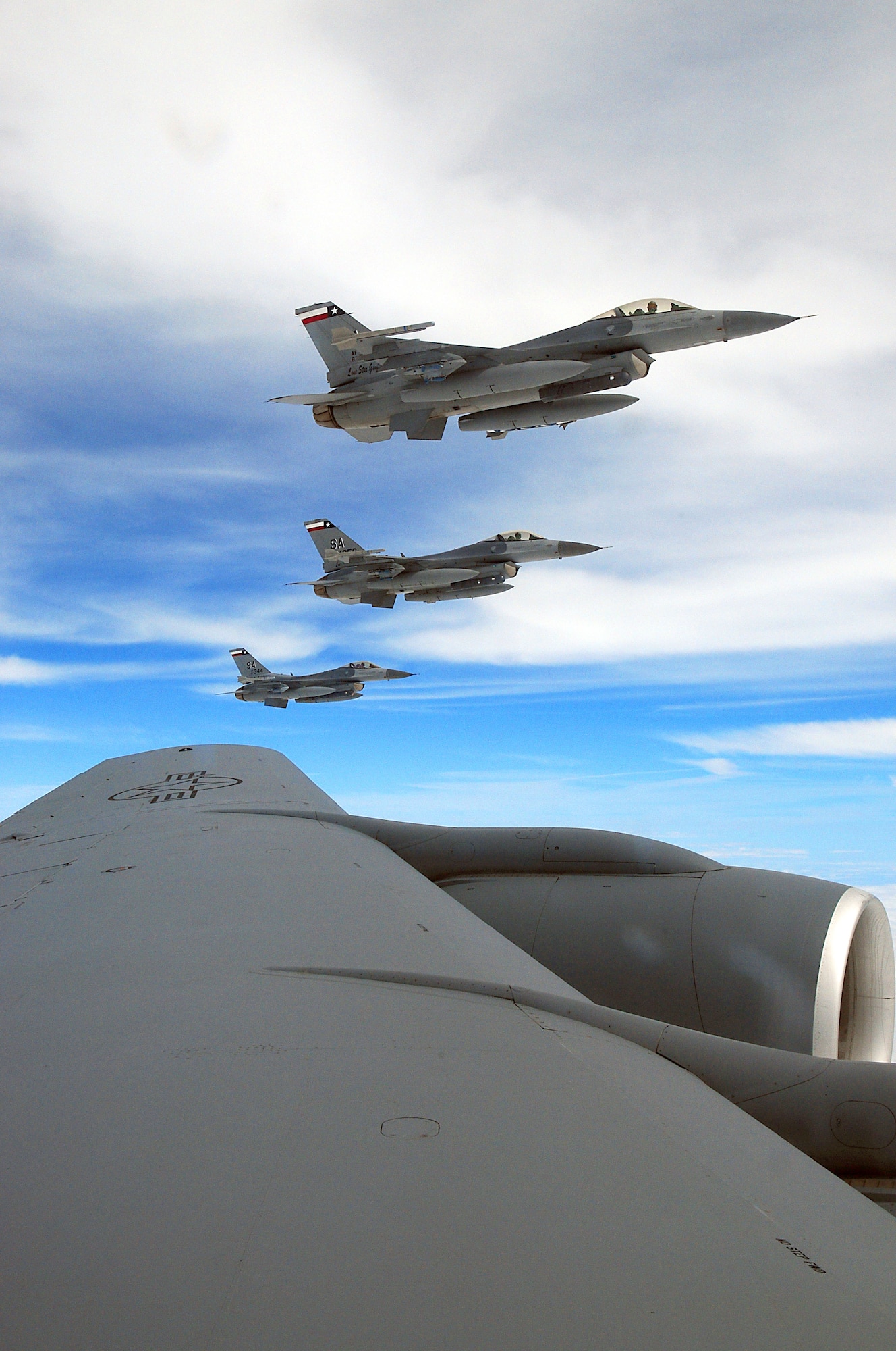 F-16s assigned to the Texas Air National Guard's 149th Fighter Wing at Lackland Air Force Base, Texas, fly alongside a KC-135 assigned to the Iowa Air National Guard's 185th Air Refueling Wing, over South Texas, on March 6, 2010. (U.S. Air Force photo by Tech. Sgt. Rene Castillo)