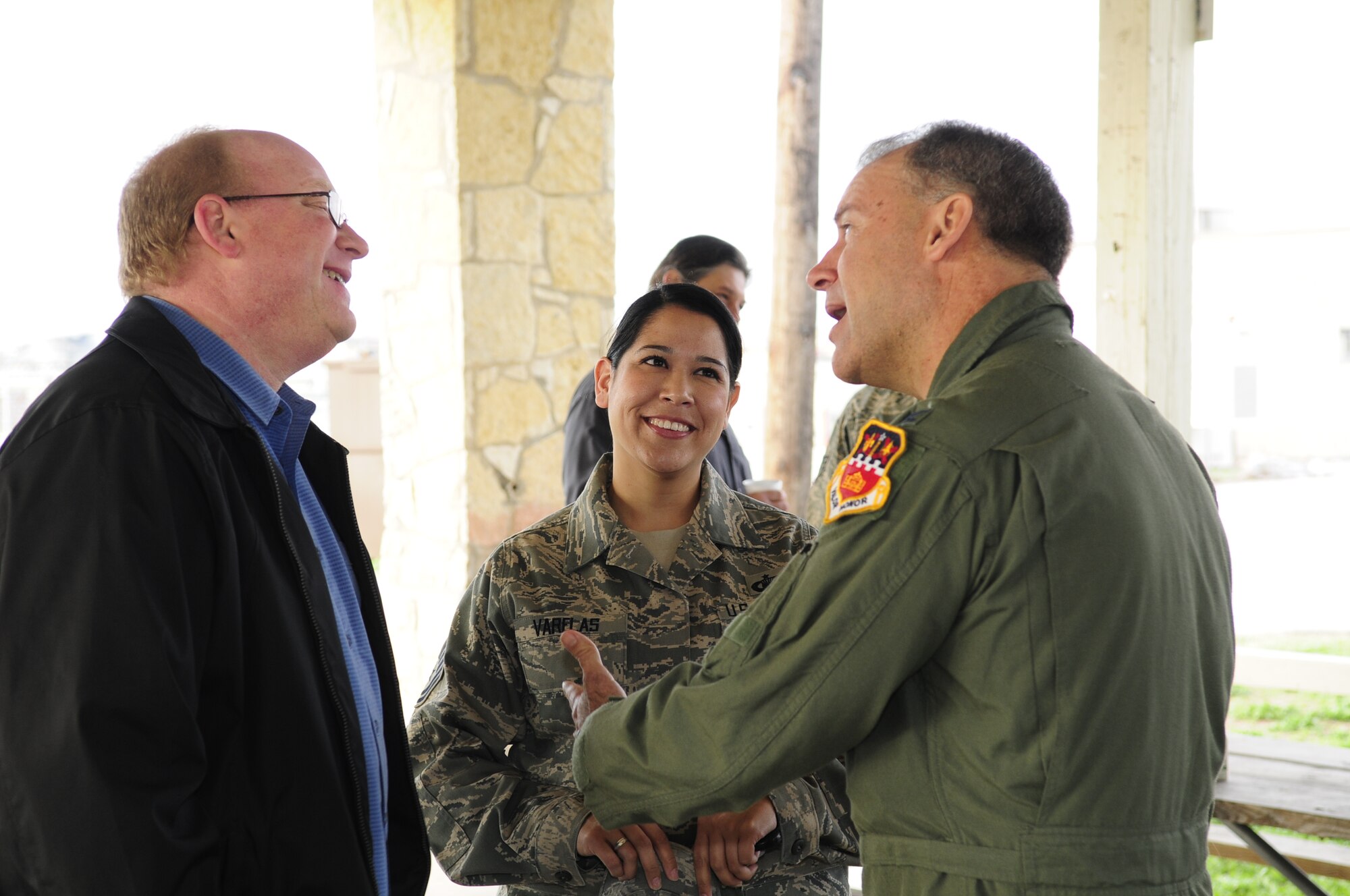 Tech. Sgt. Rachel Varelas, with the Texas Air National Guard's 149th Fighter Wing, listens to Col. Kenneth Nereson, the unit's wing commander, talk with Keith Christian, her civilian boss and manager at H-E-B, a grocery store chain with its corporate headquarters in San Antonio, Texas, as part of a "Boss Lift," which was coordinated with the Employer Support for the Guard and Reserve, at Lackland Air Force Base, Texas, on March 6, 2010. (U.S. Air Force photo by Staff Sgt. Eric L. Wilson/Released)