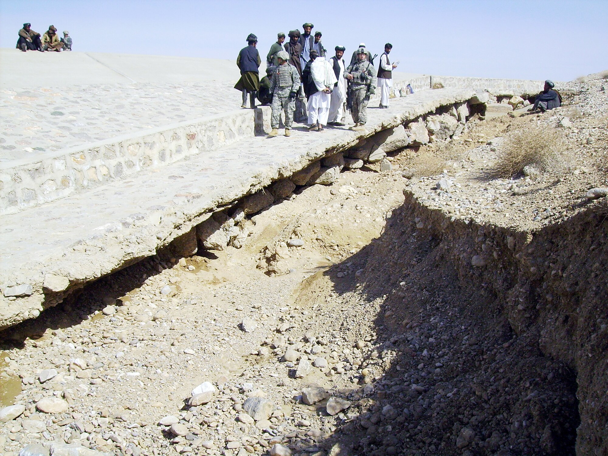 Members of Provincial Reconstruction Team Zabul confer with local Afghan leaders and contractors as they assess the deterioration of one of the roads Feb. 1, 2010, in Qalat. This road was repaired as one of the 40 commanders emergency response program projects. The partnership has enabled projects totaling more than $40 million throughout Zabul province. (U.S. Air Force photo/Capt. Greg Orbino)