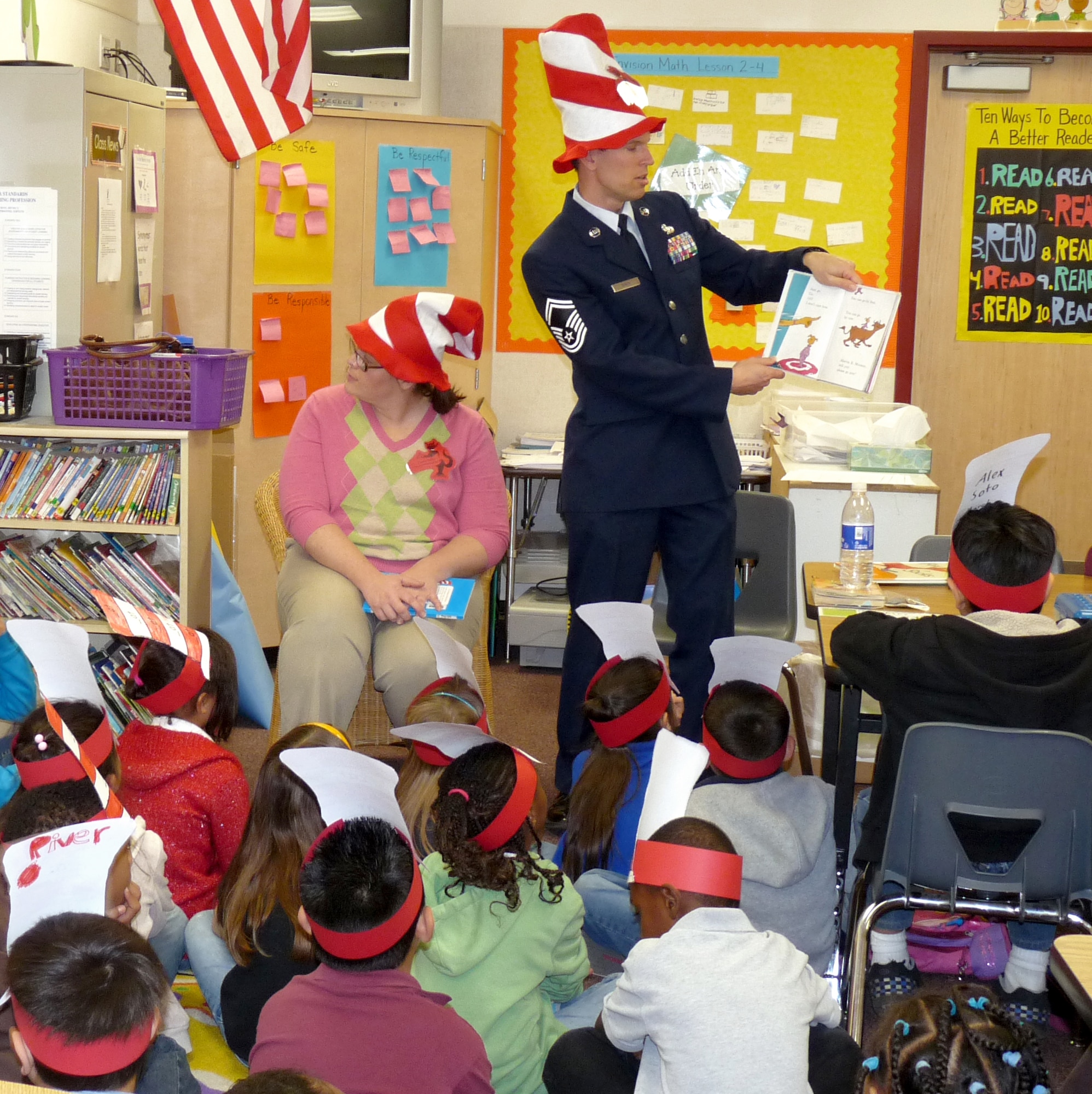 Senior Master Sgt. Todd Smith, 31st Test and Evaluation Squadron Unmanned Aerial Systems superintendent, reads to students from the Palmdale Learning Plaza March 5. The team of eight Airmen who visited the school read to more than 200 students. (Courtesy photo)