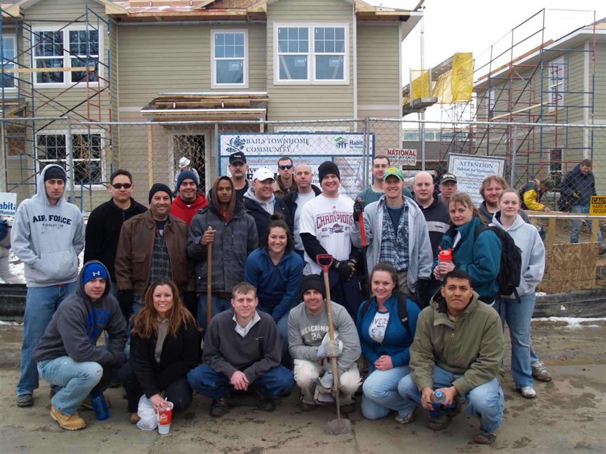 BUCKLEY AIR FORCE BASE, Colo. -- Volunteers from the 566th Intelligence Squadron pose for a group photo at the site of a Habitat for Humanity home build Feb. 12. The 566th IS is a tenant unit on Buckley Air Force Base. (U.S. Air Force photo)