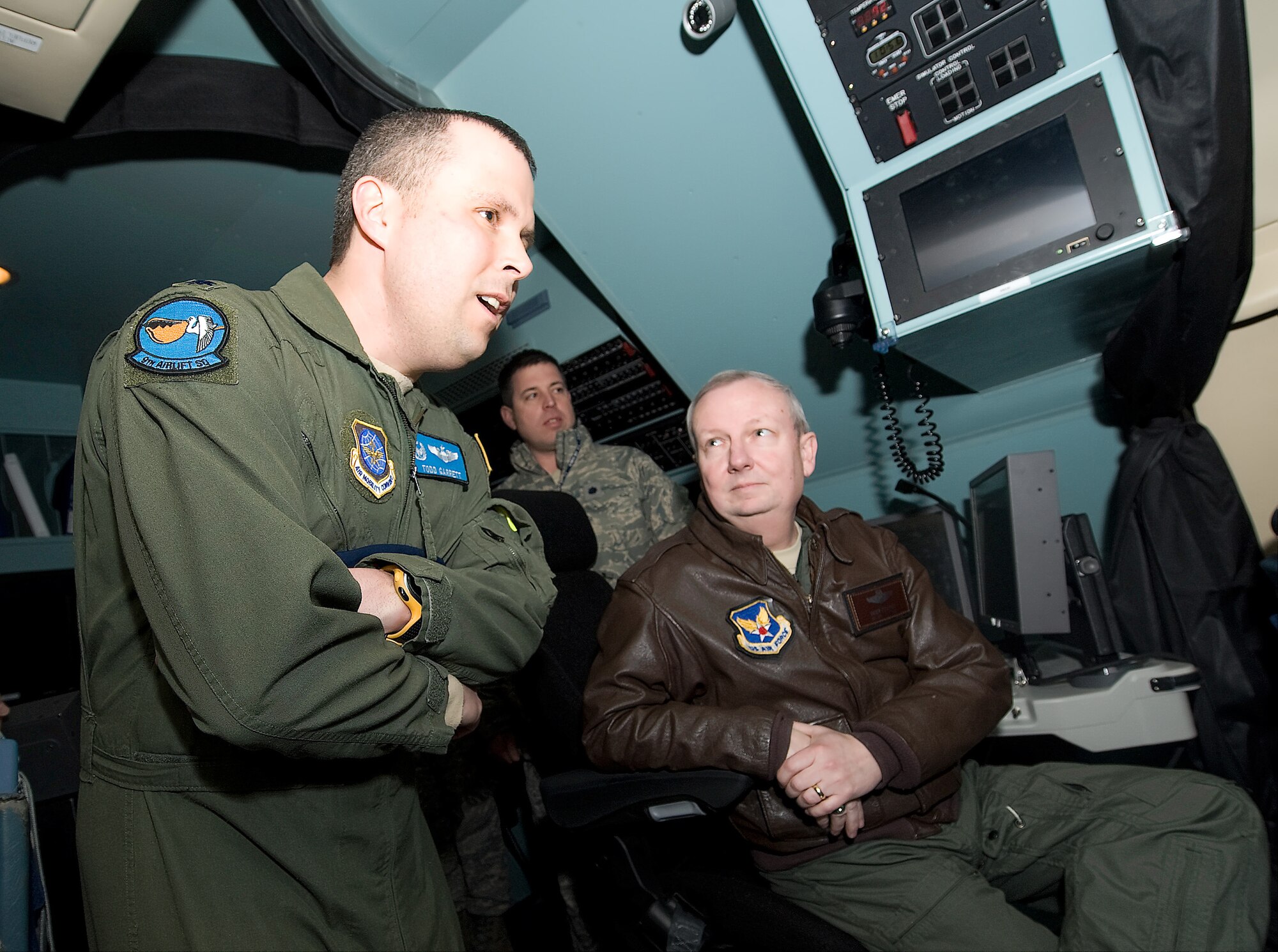 (Left) Maj. Gen. Randal Fullhart, director, Global Reach Programs, Office of the Assistant Secretary of the Air Force for Acquisition, Headquarters Air Force, Washington, D.C., speaks with Lt. Col. Todd Garrett, 9th Airlift Squadron commander, on the benefits of using simulators to train students during a tour of the simulator March 4.  (U.S. Air Force photo/Brianne Zimny)
