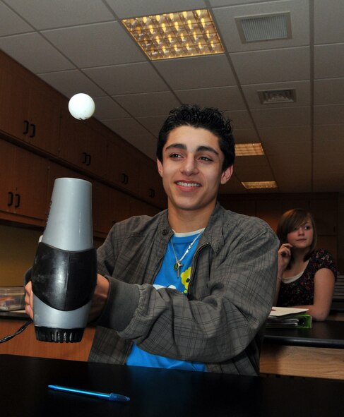 RAF FELTWELL, England – Ezequiel Sepulveda, an 8th grader at Lakenheath Middle School, learns about air currents from an experiment with a ping pong ball and a hair dryer.  The demonstration was part of a lesson on flight and aviation presented by four members of the Box D chapter of Women in Aviation, International.  (U.S. Air Force photo/Staff Sgt. Austin M. May)
