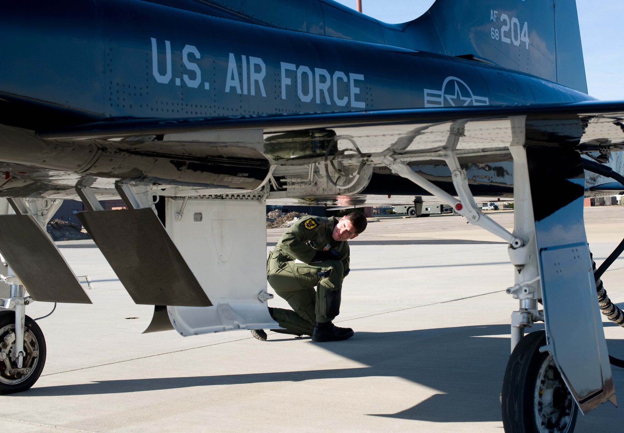 LANGLEY AIR FORCE BASE, Va. – Capt. Scott Crowell, 7th Fighter Squadron pilot, Holloman Air Force Base, N.M., conducts a pre-flight inspection for a T-38A Talon March 5.  The T-38A Talons provide cost-effective offensive and defensive counter air training for F-22 pilots at Langley. Later in March, ACC will establish a site-area task force to explore the possibility of expanding the training program beyond Holloman. (U.S. Air Force photo/Staff Sgt. Barry Loo)