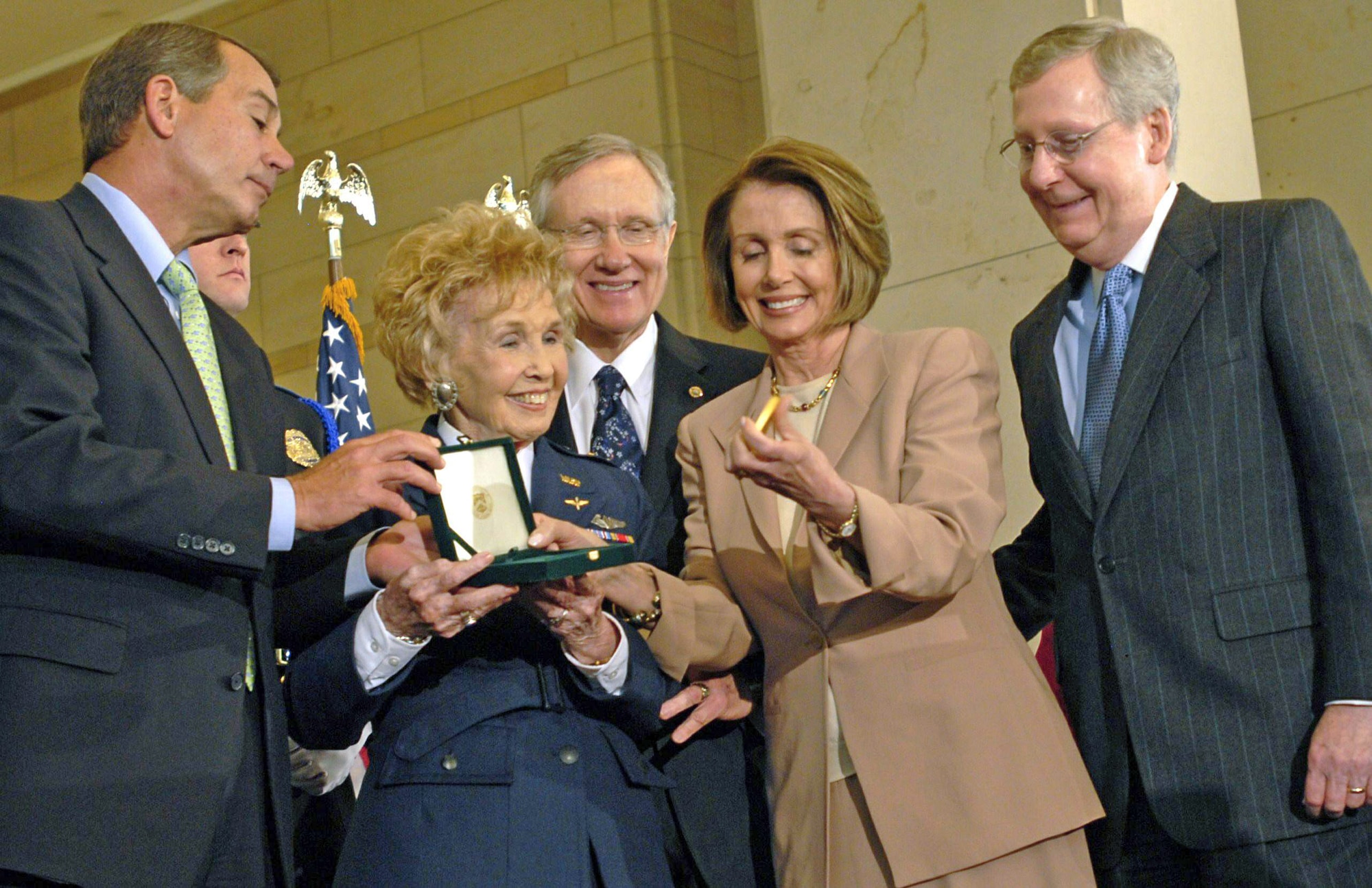 Deanie Parrish, one of the World War II Women Airforce Service Pilots and associate director of Wings Across America, accepts the Congressional Gold Medal on behalf of her fellow WASPs at the Capitol March 10, 2010. Presenting the medal are Speaker Nancy Pelosi, Rep. John Boehner, Sen. Harry Reid and Sen. Mitch McConnell. More than 200 WASPs attended the event, many of them wearing their World War II-era uniforms. (U.S. Air Force photo/Staff Sgt. J.G. Buzanowski)