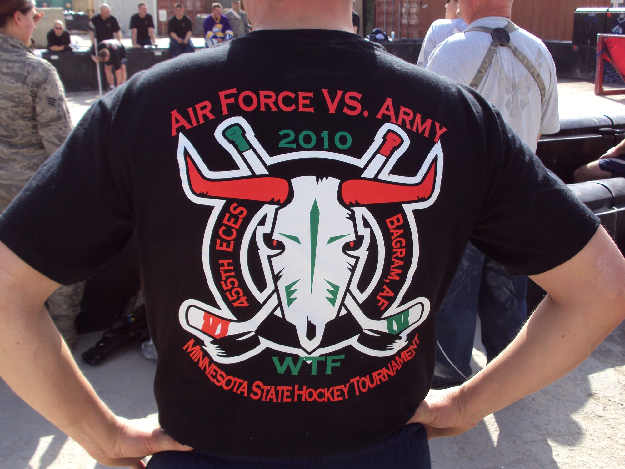 A Minnesota National Guard member proudly models a special t-shirt made especially for a floor hockey tournament at Bagram Airfield, Afghanistan in honor or the 2010 Minnesota High School State Hockey Tournament March 7, 2010.  (Photo by MN National Guard)