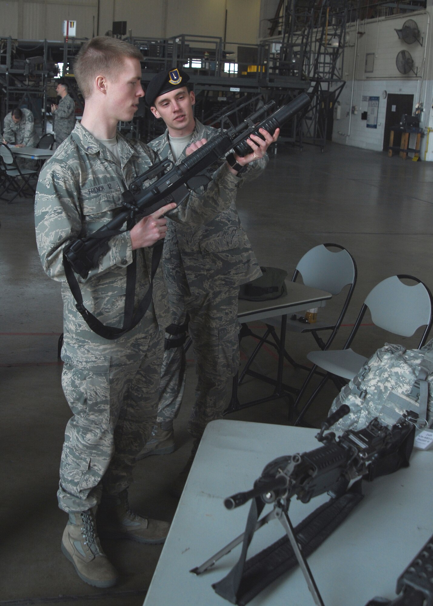 2nd Lt. Andrew York, 19th Security Forces Squadron flight commander, demonstrates an M-4 to Cadet 3rd Class James French, 19th Cadet Squadron at the U.S. Air Force Academy, Colo., during an operations fair held at Hangar 250 Saturday. From March 4 to 7, 46 cadets visited the base to gain a better perspective of the Air Force's overall mission. The 19th Airlift Wing is the 19 Cadet Squadron's sponser wing. (U.S. Air Force photo by Staff Sgt. Juan Torres)
