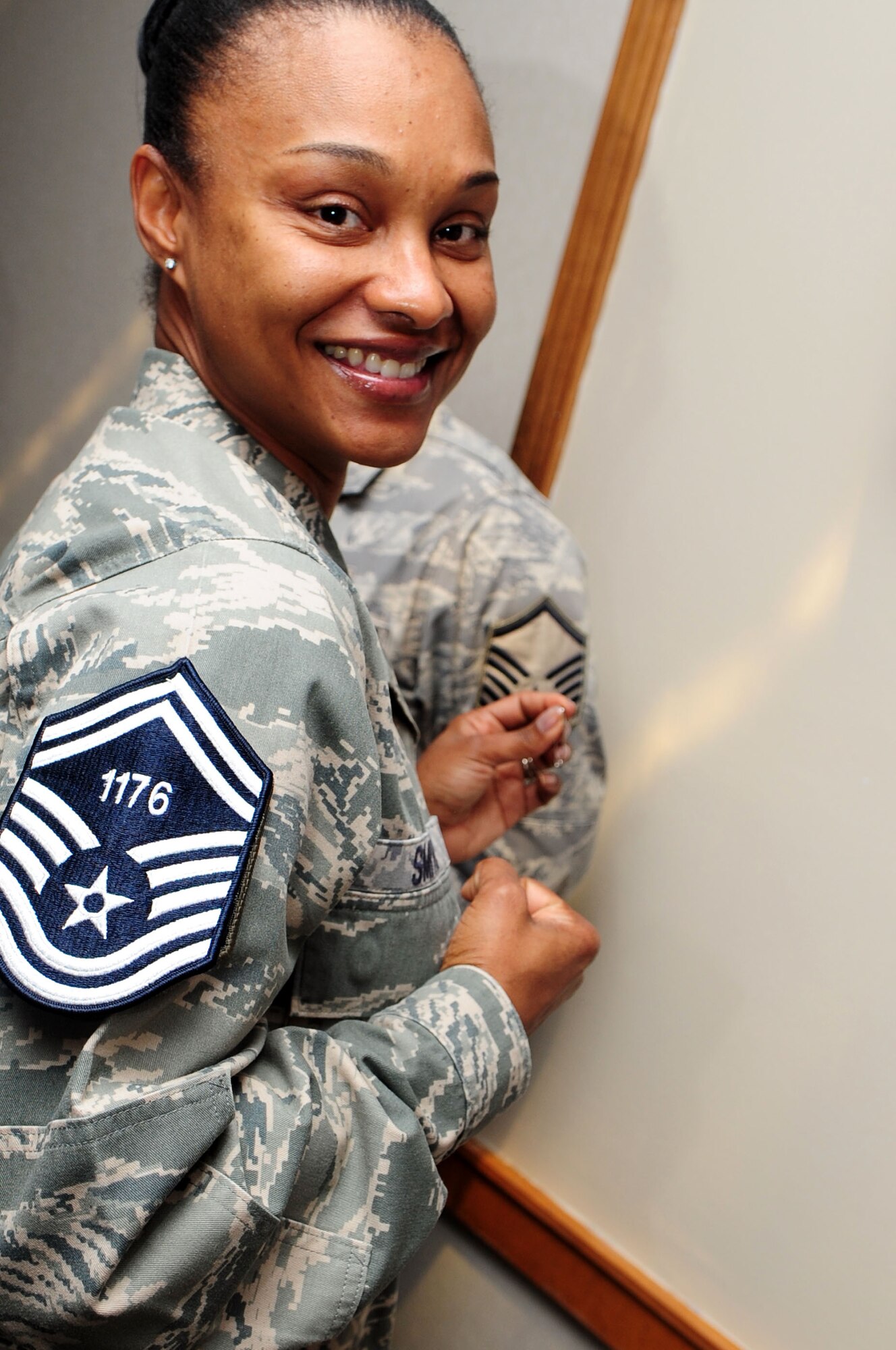 BARKSDALE AIR FORCE BASE, La. -- Master Sgt. Tizana Smith, 8th Air Force, shows off her new rank and line number during the senior master sergeant select party held at the Stripes Club March 9. (U.S. Air Force photo by Senior Airman Joanna M. Kresge)