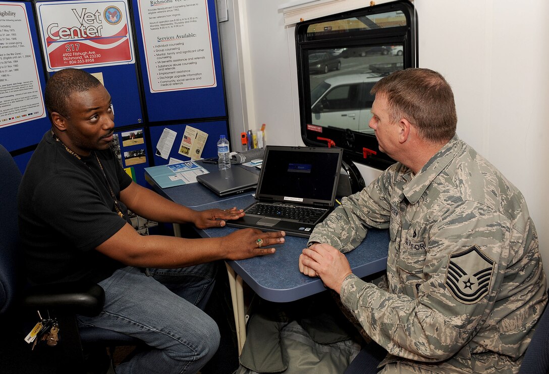 LANGLEY AIR FORCE BASE, Va. – Foster Meadors, Mobile Vet Center driver, talks with Master Sgt. Rodger Andersen, 1st Aircraft Maintenance Squadron training noncommissioned officer in charge, about enrolling himself in the U.S. Department of Veteran Affairs database March 10. Mr. Meadors travels around Virginia with a Mobile Vet Center to provide outreach and information on Veteran benefits as well as readjustment counseling and resources to active- military, reserve and National Guard members. (U.S. Air Force photo/Airman Rebecca Montez)