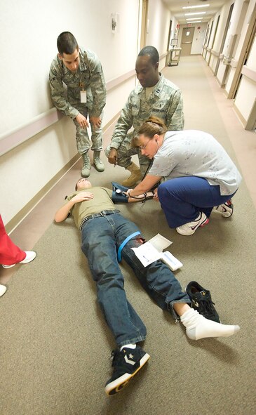 Members of the 436th Medical Group treat a ?victim? during a training exercise here March 9th.  Dover Air Force Base participated in a three-day training exercise to ensure personnel are trained and prepared for any situation.  (U.S. Air Force photo/Brianne Zimny) 
