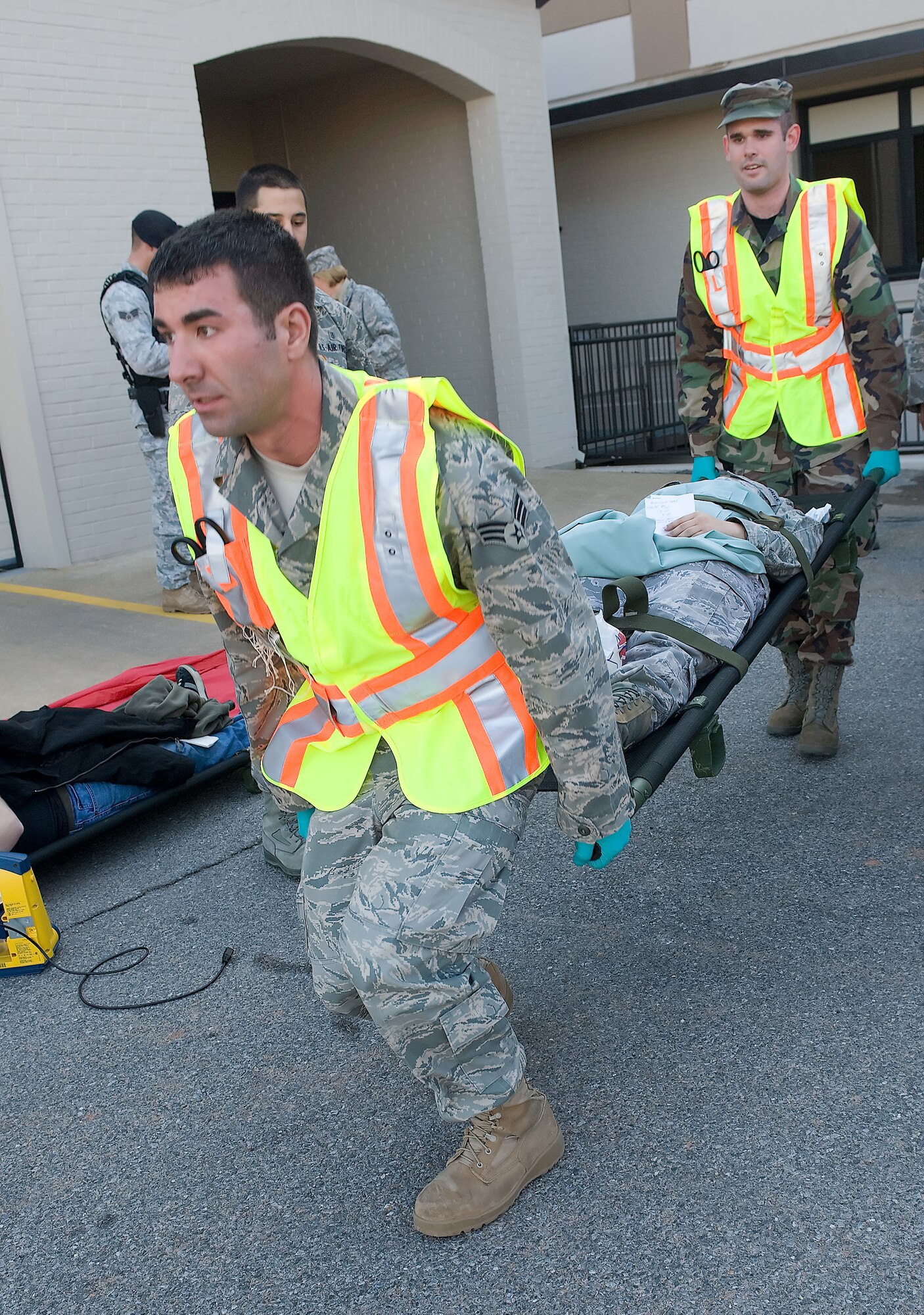 Members of the 436th Medical Group transport an ?accident victim? to a treatment area during a training exercise March 9th.  Dover Air Force Base participated in a three-day training exercise which included dressing up personnel as accident victims.  (U.S. Air Force photo/Brianne Zimny)   
