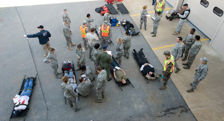 436th Medical Group personnel perform triage on ?accident victims? during a training exercise March 9th as evaluators takes notes on their performance.  Dover Air Force Base participated in a three-day training exercise which included dressing up personnel as accident victims.  (U.S. Air Force photo/Jason Minto)