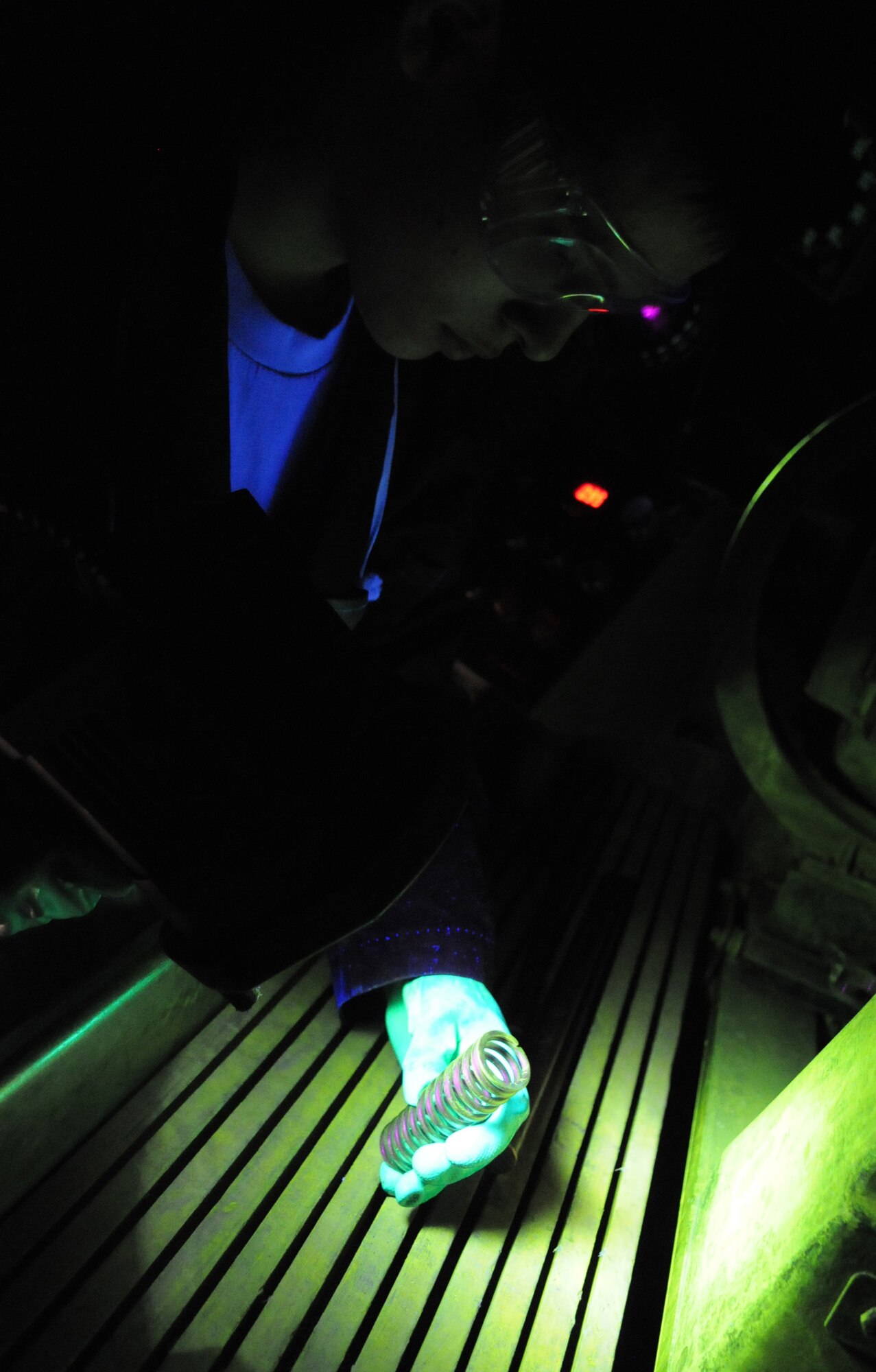 RAF MILDENHALL, England – Airman 1st Class Christopher Bovill, 100th Maintenance Group Non-Destructive Inspection technician, inspects a spring after it was run through a magnetic particle machine at the NDI shop March 9. (U.S. Air Force photo/ Staff Sgt. Jerry Fleshman)