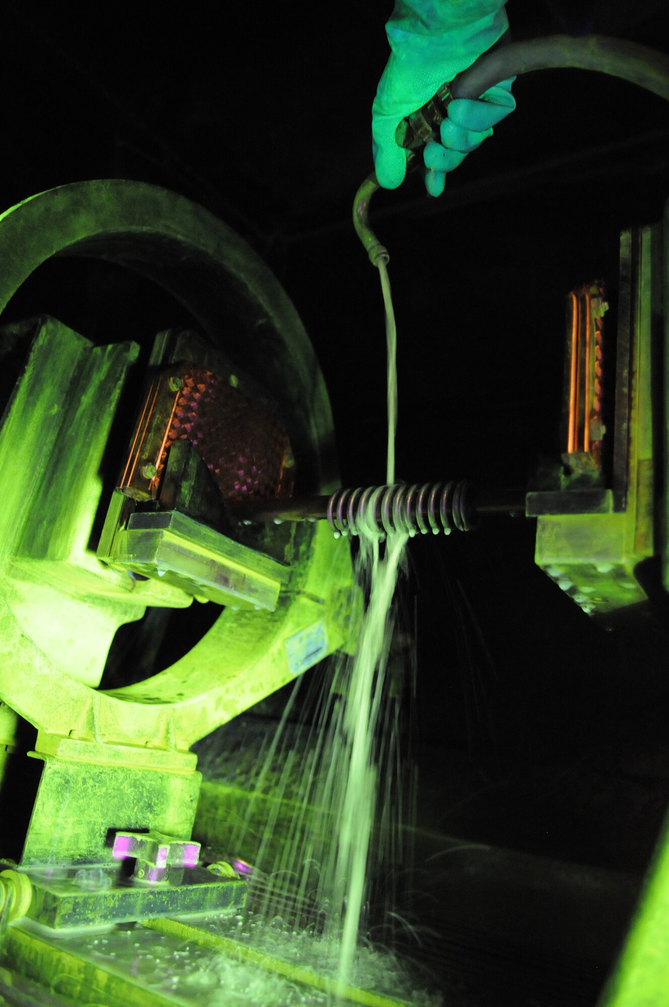 RAF MILDENHALL, England – Airman 1st Class Christopher Bovill, 100th Maintenance Group Non-Destructive Inspection technician, gives a spring a microscopic iron bath with a magnetic particle machine at the NDI shop March 9. The machine uses magnetic current for the iron particles to attach to any cracks that might not be visible to the naked eye. (U.S. Air Force photo/ Staff Sgt. Jerry Fleshman)