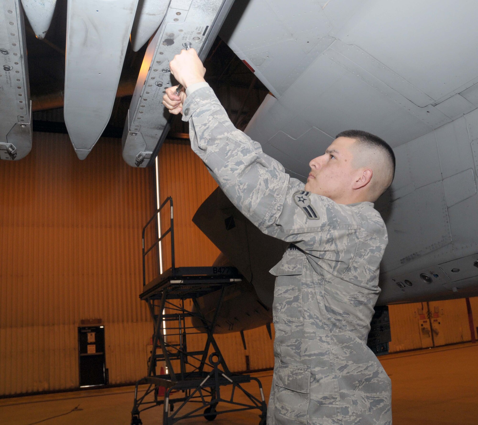 Airman 1st Class Robert Cabral, 748th Aircraft Maintenance Squadron weapons load team member, ensures the railing hooks are ready to load a missile on an F-15 Strike Eagle at RAF Lakenheath, England, Mar. 10. He was nominated for the Liberty Spotlight by his chain of command because he demonstrates the Air Force core value of "Service Before Self." (U.S. Air Force photo by Staff Sgt. Connor Estes)

