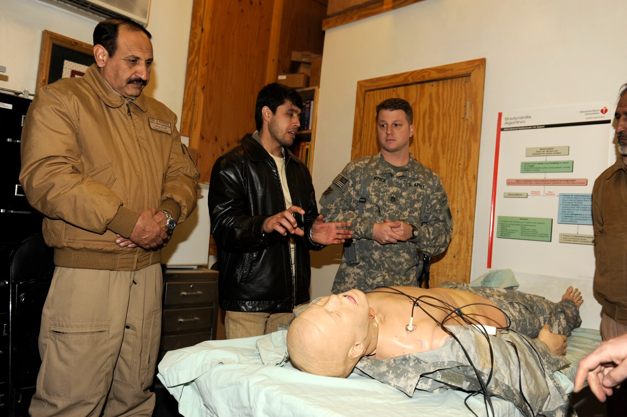 U.S. Army Staff Sgt. Joseph McCormick, Charley 23, Dust-off, shows Afghan Col. Abdul Rasoul, surgeon general, Afghan National Army Air Corps, how U.S. forces train for medical emergencies at Bagram Airfield, Afghanistan, March 6, 2010. The ANAAC members were at Bagram to discuss the evolution of the medical evacuation mission in Afghanistan. (U.S. Air Force photo by/ Tech. Sgt. Jeromy K. Cross/released)