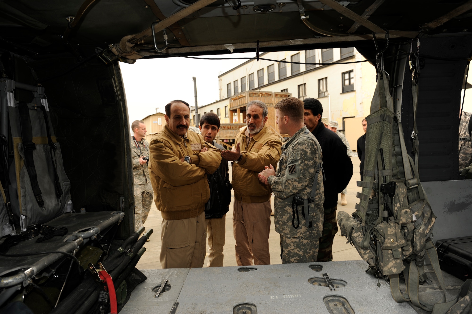 U.S. Army Staff Sgt. Joseph McCormick, Charley 23, Dust-off, gives soldiers from the Afghan National Army Air Corps a tour of a UH-60 Black Hawk at Bagram Airfield, Afghanistan, March 6, 2010. The ANAAC members were at Bagram to discuss the evolution of the medical evacuation mission in Afghanistan. (U.S. Air Force photo by/ Tech. Sgt. Jeromy K. Cross/released) 