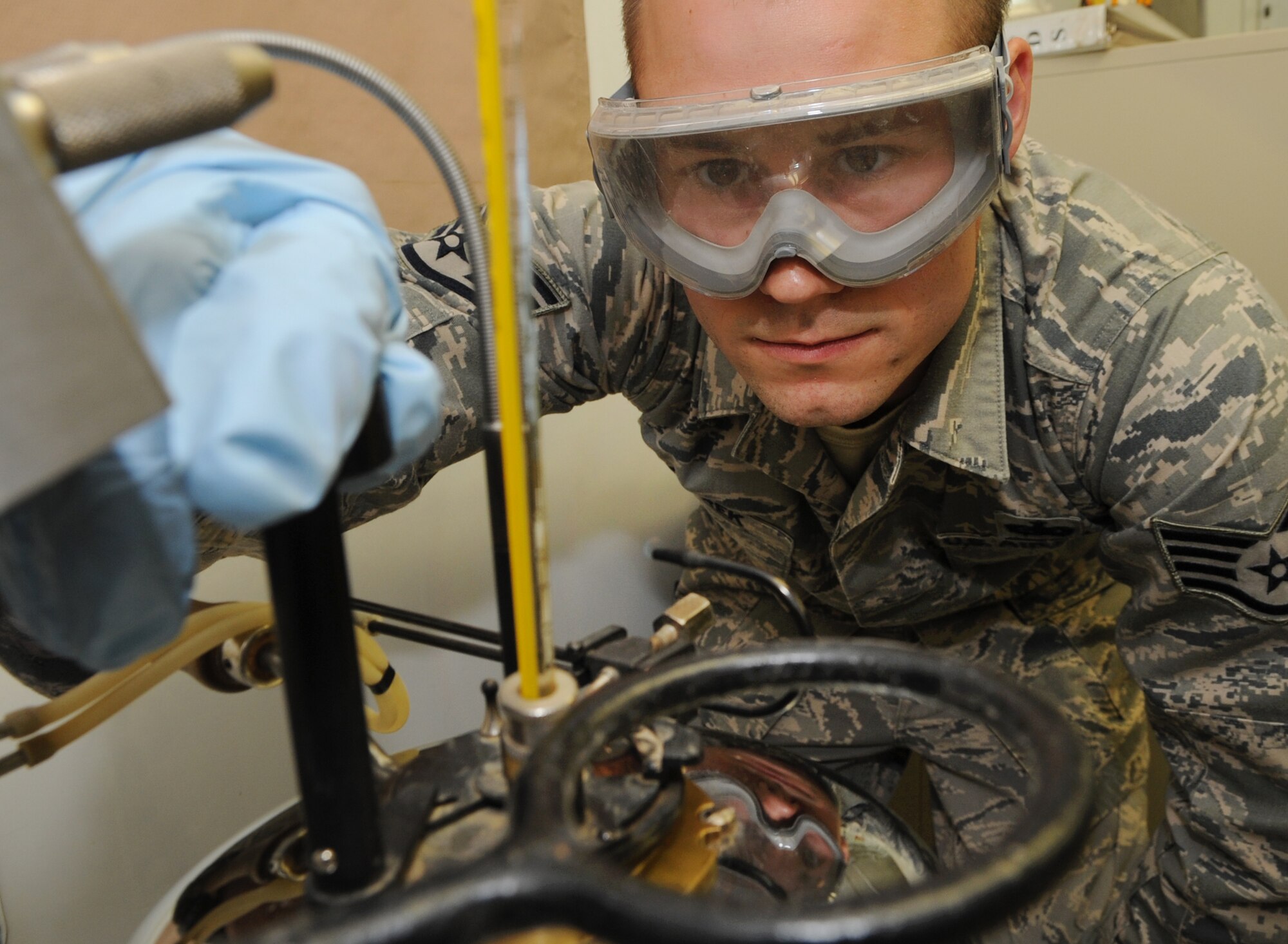 Staff Sgt. Dustyn Marek, 506th Expeditionary Logistics Readiness Squadron fuels laboratory technician, tests fuel quality at Kirkuk Regional Air Base, Iraq on March 6, 2010.   Sergeant Marek samples the fuel to make sure it's up to military specifications.  Sergeant Marek is deployed from McChord AFB, Wash.  (U.S. Air Force photo/Staff Sgt. Tabitha Kuykendall/Released)	 