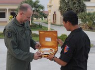PHNOM PENH, Kingdom of Cambodia -- Brig. Gen. Hun Manet (right), Royal Cambodian Armed Forces National Counter-Terrorism Special Forces commander, hands a memento Col. Robert Toth, 353rd Special Operations Group commander, after the closing ceremonies of a combined training exercise here Feb. 24 Airmen from the 353rd Special Operations Group deployed here Feb. 21-24 to support a training exercise between U.S. Army Special Forces and Royal Cambodian Armed Forces National Counter-Terrorism Special Forces. (U.S. Air Force photo by Tech. Sgt. Aaron Cram)