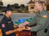 PHNOM PENH, Kingdom of Cambodia -- Col. Robert Toth (right), 353rd Special Operations Group commander, hands Brig. Gen. Hun Manet, Royal Cambodian Armed Forces National Counter-Terrorism Special Forces commander, a memento after the closing ceremonies of a combined training exercise here Feb. 24 Airmen from the 353rd Special Operations Group deployed here Feb. 21-24 to support a training exercise between U.S. Army Special Forces and Royal Cambodian Armed Forces National Counter-Terrorism Special Forces. (U.S. Air Force photo by Tech. Sgt. Aaron Cram) 