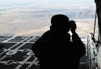 OVER PHNOM PENH, Kingdom of Cambodia -- A jumpmaster from the Royal Cambodian Armed Forces records RCAF soldiers as they parachute from the back of a MC-130P Combat Shadow here Feb. 22. Airmen from the 353rd Special Operations Group deployed here Feb. 21-24 to support a training exercise between U.S. Army Special Forces and Royal Cambodian Armed Forces National Counter-Terrorism Special Forces. More than 90 U.S. and RCAF soldiers combined to mark the first-ever combined airdrop between U.S. and Cambodian forces. (U.S. Air Force photo by Tech. Sgt. Aaron Cram)