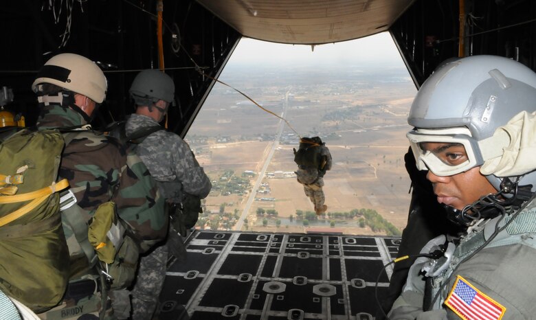 OVER PHNOM PENH, Kingdom of Cambodia -- Senior Airman Darrell Waterman, a 17th Special Operations Squadron loadmaster, counts U.S. Army Special Forces members as they parachute from the back of a MC-130P Combat Shadow here Feb. 22. Airmen from the 353rd Special Operations Group deployed here Feb. 21-24 to support a training exercise between U.S. Army Special Forces and Royal Cambodian Armed Forces National Counter-Terrorism Special Forces. (U.S. Air Force photo by Tech. Sgt. Aaron Cram)
