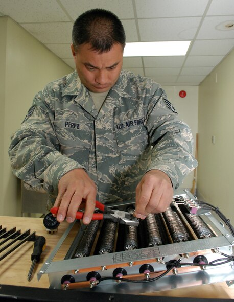 Staff Sgt. Frank Perez, 254th Rapid Engineer Deployable Heavy Operational Repair Squadron Engineers (RED HORSE) Squadron heating, ventilation, and air conditioning technican, repairs a defective heating element March 11 at Rush Park at Osan Air Base, South Korea. (U.S. Air Force photo/Staff Sgt. Steve Grever)