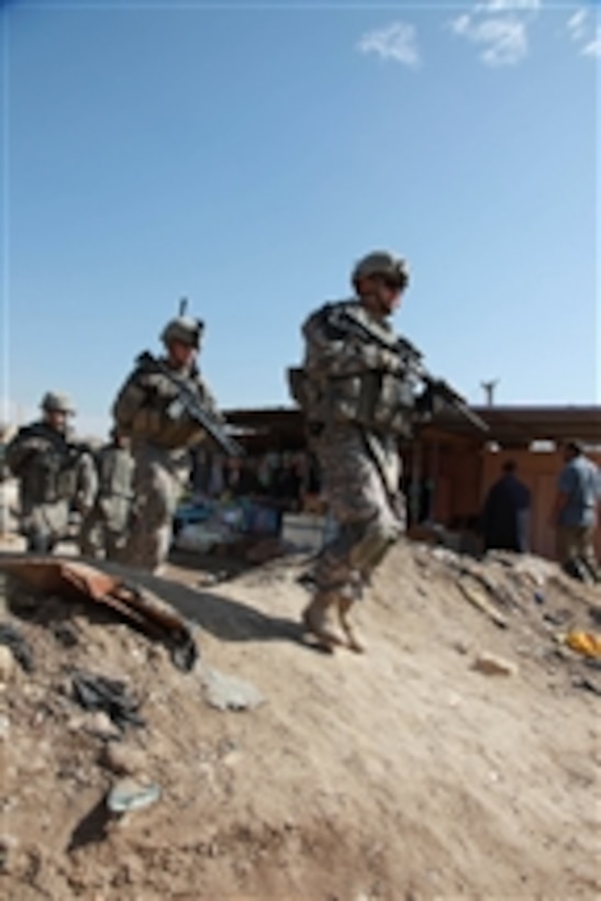 U.S. Army soldiers of 1st Battalion, 38th Infantry Regiment, 4th Stryker Brigade Combat Team, 2nd Infantry Division walk through a market in Ebnkathwer, Iraq, on Mar. 3, 2010.  The mission was part of a pre-election battlefield circulation to give a survey on how the sector is functioning prior to the elections.  