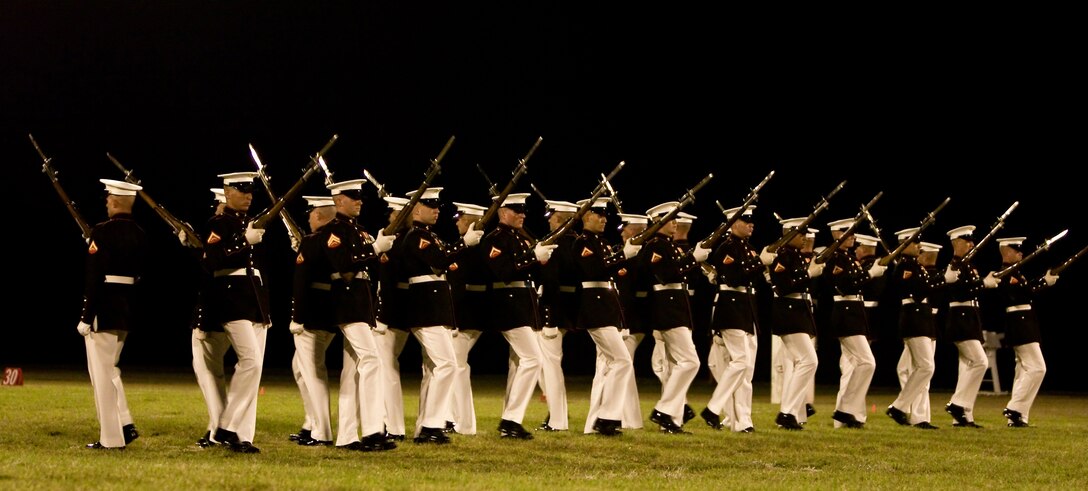 Marines with the Silent Drill Platoon perform close order drill movements during a Marine Corps Battle Color Ceremony March 12 on Bordelon Field, Camp H.M Smith, Hawaii. The Silent Drill platoon is known for the difficult close order drill techniques they perform without any verbal commands.