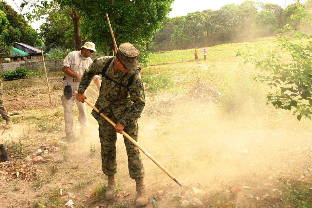 Lance Cpl. Justin Pilkington, a motor-transport operator with Combat Logistics Battalion 31 (CLB-31), 31st Marine Expeditionary Unit (MEU), rakes the lawn and performs with general clean-up at St. Juliana School during a community relations (COMREL) event, March 12. CLB-31 took an operational pause during exercise Balikatan 2010 (BK ’10) to build bridges of friendship with the local community.