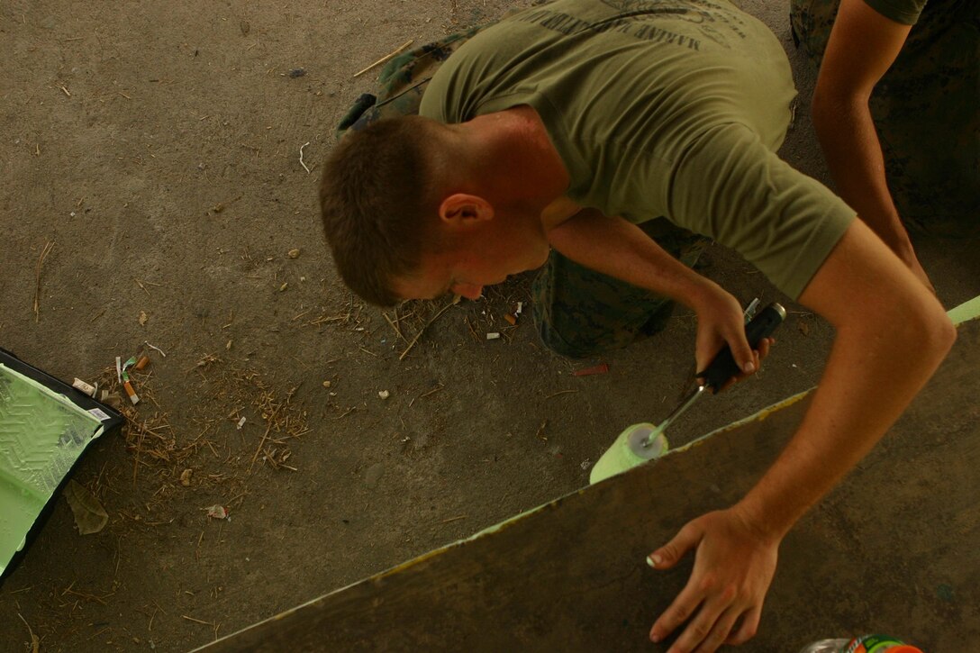 Lance Cpl. Jordan Fife, a radio repairman with Combat Logistics Battalion 31 (CLB-31), 31st Marine Expeditionary Unit (MEU), paints the St. Juliana High School graduation stage during a community relations (COMREL) event, March 12.  CLB-31 took an operational pause during exercise Balikatan 2010 (BK ’10) to build bridges of friendship with the local community.