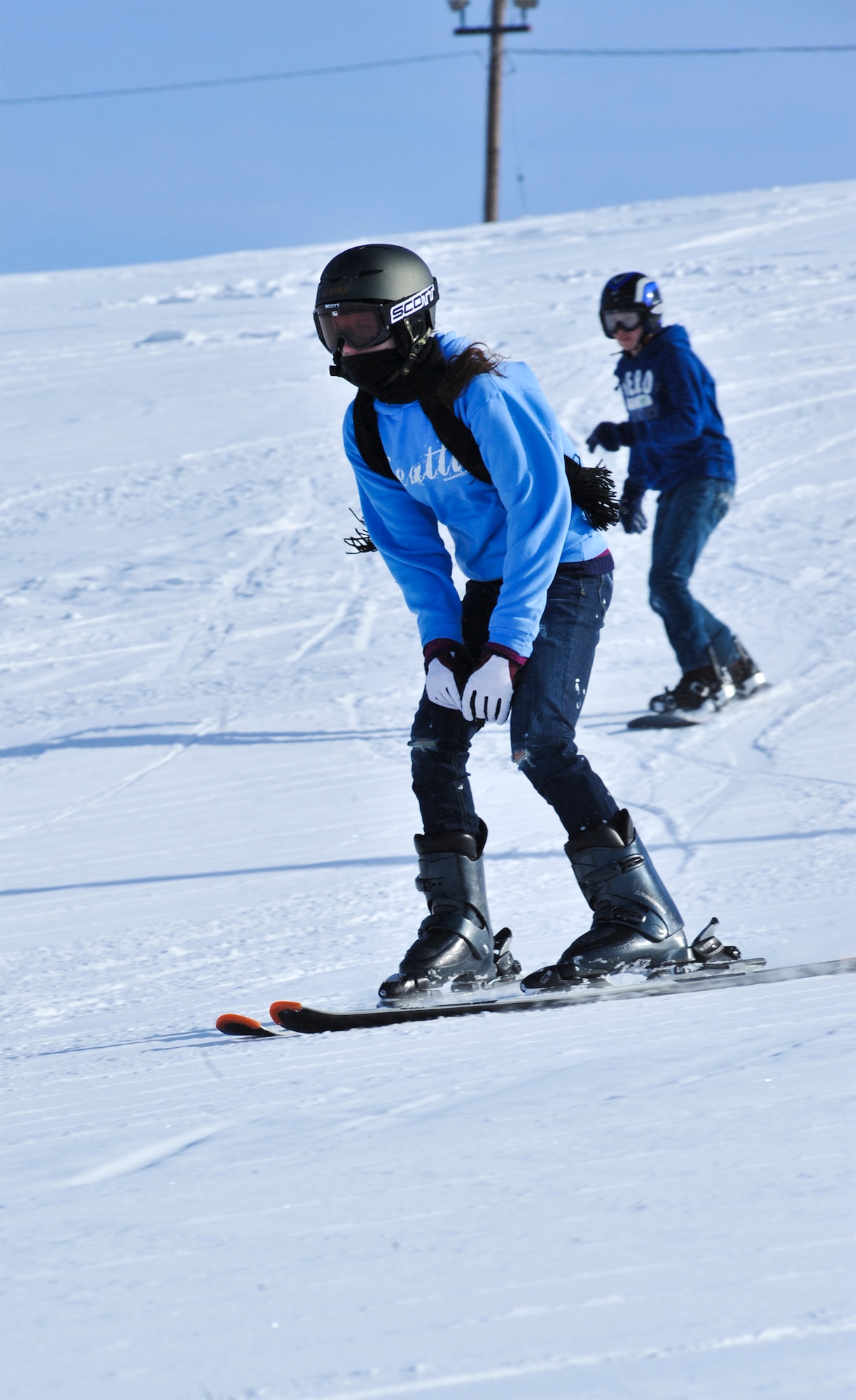 ELMENDORF AIR FORCE BASE, Alaska – Two children make their way down Elmendorf’s Hillberg on skis and a snowboard March 11. March 8-12 was spring break for most of the schools in and around Elmendorf, giving children and their parents the opportunity to get out and enjoy themselves. (Air Force photo/Airman 1st Class Christopher Gross)