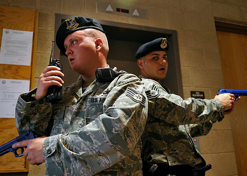 HOLLOMAN AIR FORCE BASE, N.M. -- Staff Sgt. Craig Ames and Staff Sgt. Michael Morris, 49th Security Forces Squadron, conduct a building sweep at the Domenici Fitness and Sports Center, March 11, 2010, during exercise Coronet Gold Rush 10-02, also known as an active shooter exercise. Some of the objectives in the exercise were to address communications, response procedures and command and control between on site personnel and base command and control. (U.S. Air Force photo by Staff Sgt. Anthony Nelson Jr.)