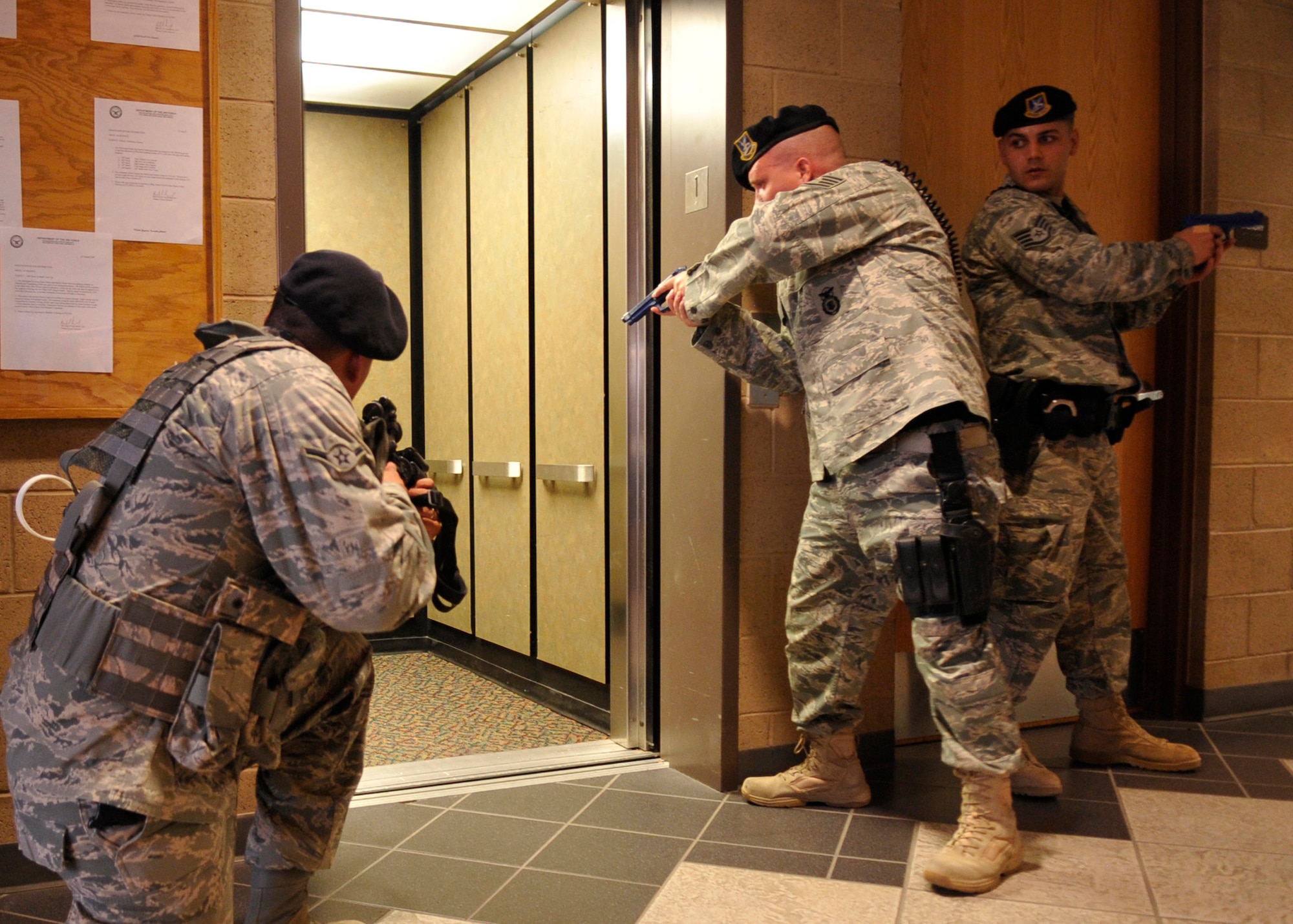 HOLLOMAN AIR FORCE BASE, N.M. -- Airman Pedro Escobar, Staff Sgt. Craig Ames and Staff Sgt. Michael Morris, 49th Security Forces Squadron, conduct a building sweep at the Domenici Fitness and Sports Center, March 11, 2010, during exercise Coronet Gold Rush 10-02, also know as an active shooter exercise. Some of the objectives in the exercise were to address communications, response procedures and command and control between on-site personnel and base command and control. (U.S. Air Force photo by Staff Sgt. Anthony Nelson Jr.)