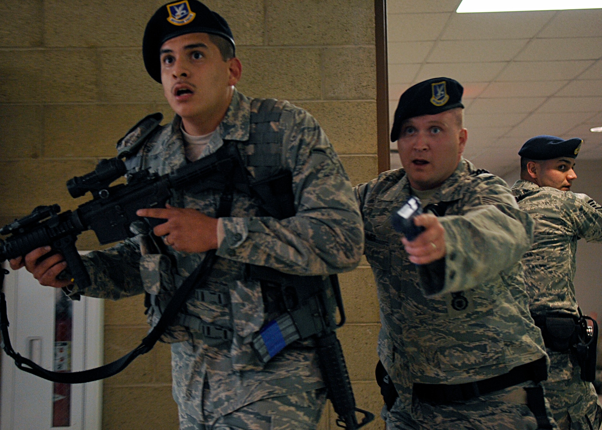 HOLLOMAN AIR FORCE BASE, N.M. -- Airman Pedro Escobar, Staff Sgt. Craig Ames and Staff Sgt. Michael Morris, 49th Security Forces Squadron, conduct a building sweep at the Domenici Fitness and Sports Center, March 11, 2010, during exercise Coronet Gold Rush 10-02. The active shooter exercise helped prepare the 49th Fighter Wing members for future exercises and possible real-world situations. (U.S. Air Force photo by Staff Sgt. Anthony Nelson Jr.)
