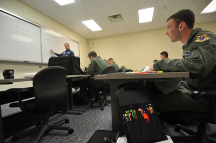 Second Lt. Chris Creveling (right), a 562nd Flying Training Student at, Randolph Air Force Base, TX, listens to instructions for preparing his flight plan. Lieutenant Creveling is a member of the last graduating class of Combat System Operators at Randolph. (U.S. Air Force photo by Steve White)