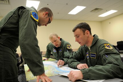 Second Lt. Jestin Boelman (left), 2nd Lt. Daniel Howe (center), and 2nd Lt. Chris Creveling (right), all 562nd Flying Training Squadron Combat Systems Officer students at Randolph Air Force Base, TX, go over a map in flight plan preperation in class. They are training to become Combat Syetem Operators and will graduate in October 2010 as the last class to graduate from Randolph.  (U.S. Air Force photo by Steve White)