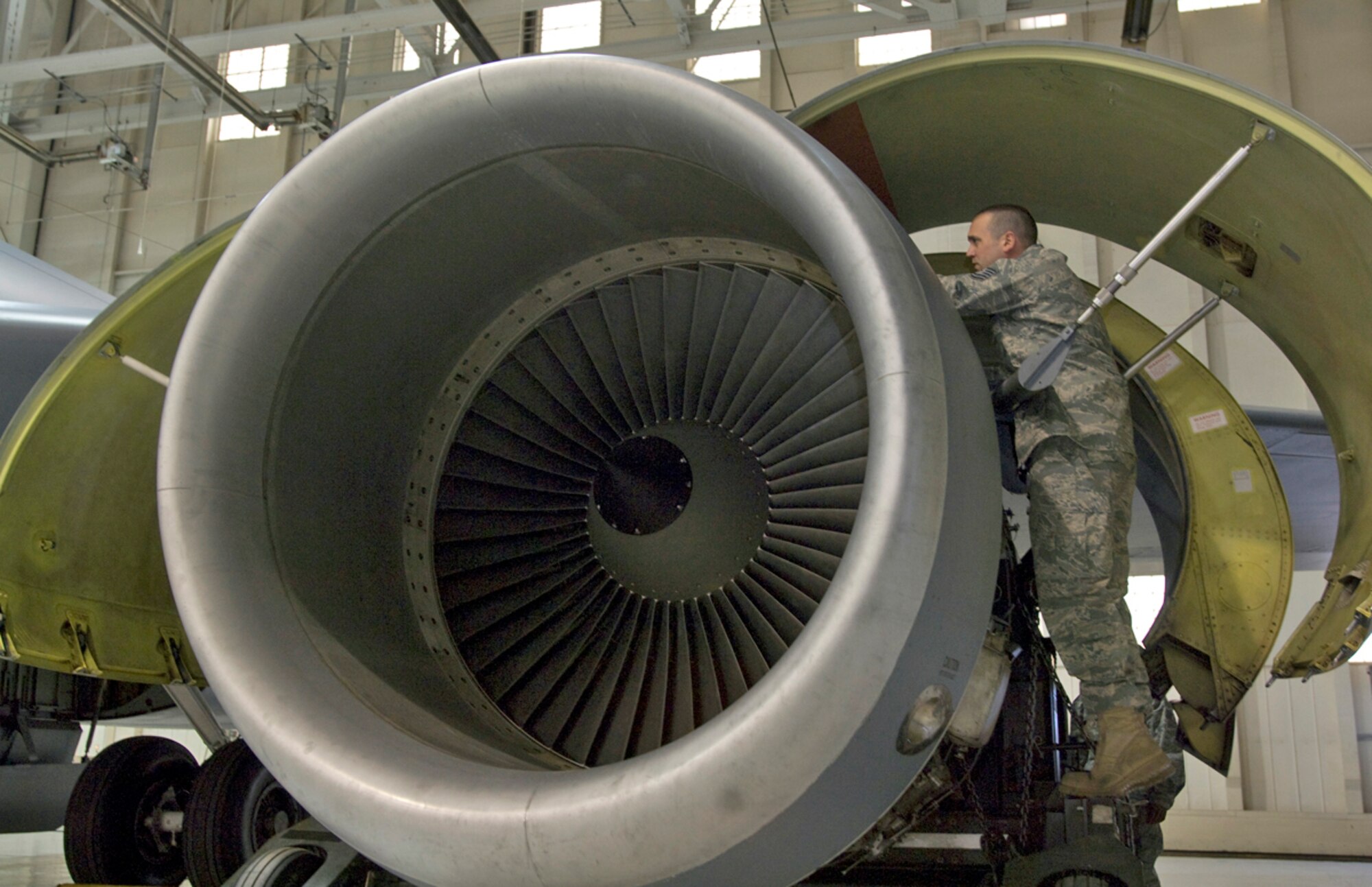 Tech. Sgt. Stefan Sianis inspects a KC-135R Stratotanker F108-100 engine before it?s lowered from the aircraft March 3, 2010, at McConnell Air Force Base, Kan. Sergeant Sianis is a mechanic assigned to the 22nd Aircraft Maintenance Squadron. (U.S. Air Force photo/Senior Airman Abigail Klein)
