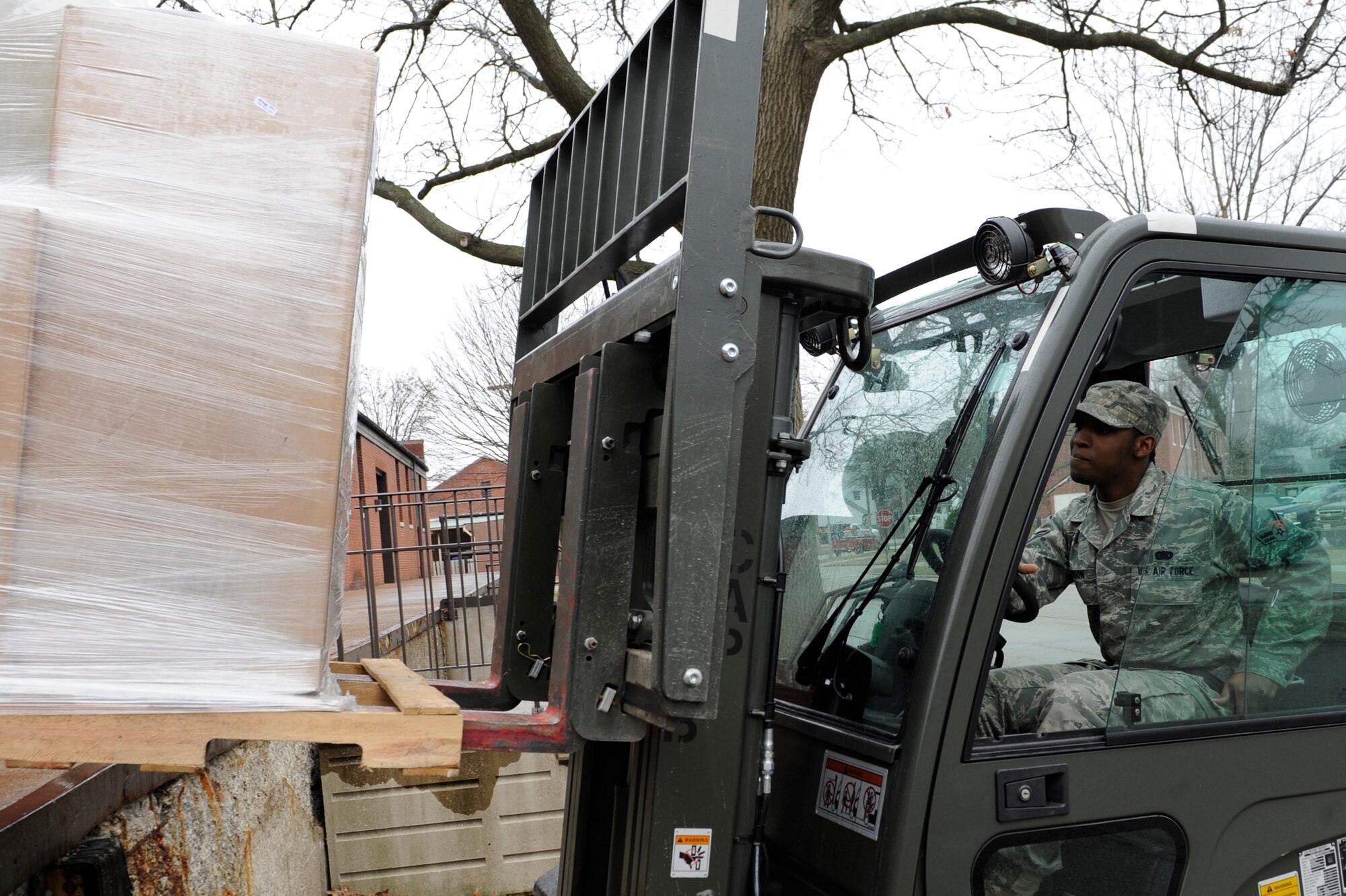 SCOTT AIR FORCE BASE, Ill -- Airman 1st Class Jamaul Anderson, 375th Civil Engineer Squadron, Material Acquisitions warehouse clerk, lifts a pallet of supplies off the loading dock to be delivered to another CES section, March 12, 2010 at Scott. Material Acquisitions operates on an annual $5.5 million budget to supply the Operations Support Flight with the materials needed to perform all minor maintenance and base infrastructure upkeep. (U.S. Air Force photo/ Senior Airman Wesley Farnsworth)