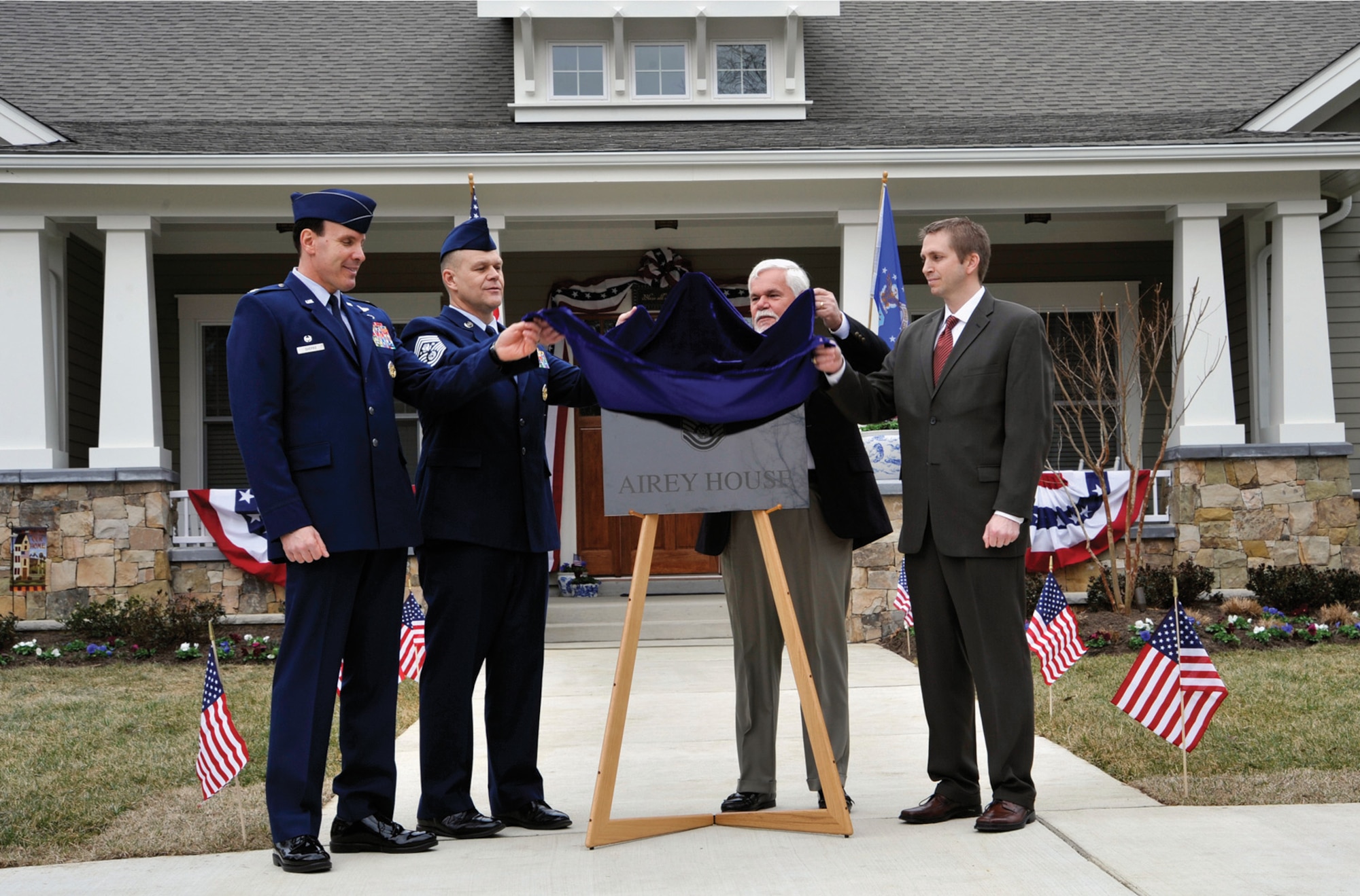 Colonel Steven Shepro (from left), Joint Base Andrews and 316th Wing commander; Chief Master Sgt. of the Air Force James A. Roy; retired Chief Master Sgt. Dale Airey; and Mike Dowling, a representative of Clark Realty, unveil a plaque during a dedication ceremony March 10, 2010, at 1 Airey Court, Joint Base Andrews, Md.  The chief master sergeant of the Air Force's new quarters, now "Airey House," were dedicated to the first chief master sergeant of the Air Force, Paul W. Airey.  (U.S. Air Force photo/ Airman 1st Class Perry Aston)