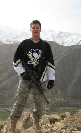 PANJSHIR PROVINCE, Afghanistan-- Air Force 2nd Lt. Jason Smith, Provincial Reconstruction Team Panjshir Public Affairs officer, dons a Pittsburgh Penguin jersey after climbing a large hill near Forward Operating Base Lion in the Panjshir Province of Afghanistan. Lieutenant Smith, a Pittsburgh native and Penguin fan, will be deployed to Afghanistan for almost a year where he will work to promote security, governance and reconstruction efforts. (U.S. Army photo by Capt. Benjamin Fitting)