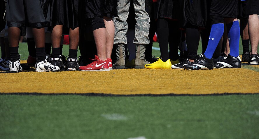 MOODY AIR FORCE BASE, Ga. -- Moody Airmen congregate at the center of the football field after shaking hands with Marines from the Marine Corps Logistics Base in Albany, Ga., at the Valdosta Stadium in Valdosta, Ga., March 6.  The Airmen walked away with a blowout win over the Marines team with a final score of 31-6. (U.S. Air Force photo by Airman 1st Class Joshua Green)