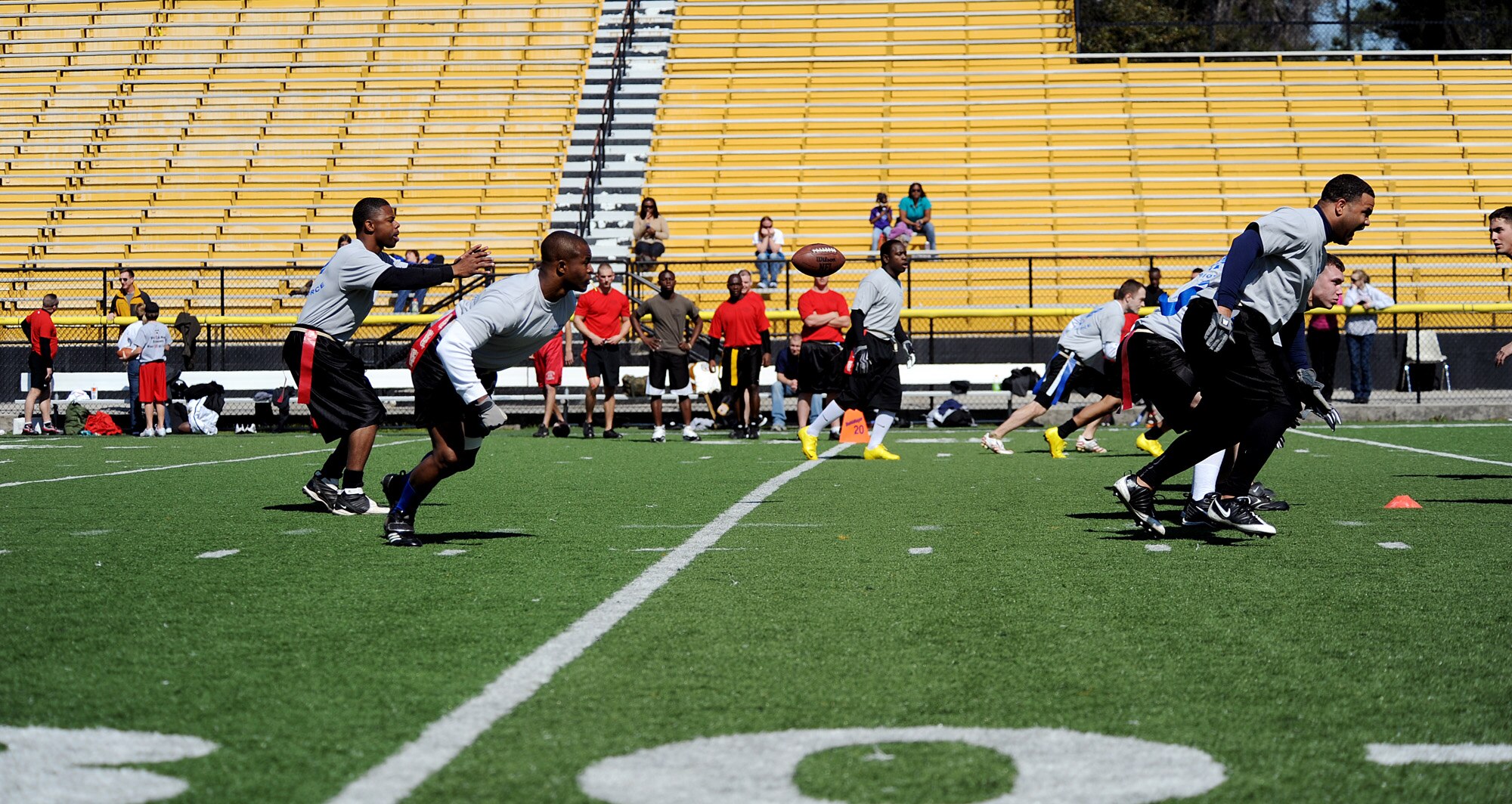 MOODY AIR FORCE BASE, Ga. -- Moody Airmen prepare to attack on offense after the snap during a flag football game at the Valdosta Stadium in Valdosta, Ga., March 6. The flag football game was a competition between Moody Airmen and Marines from the Marine Corps Logistics Base in Albany, Ga. (U.S. Air Force photo by Airman 1st Class Joshua Green)