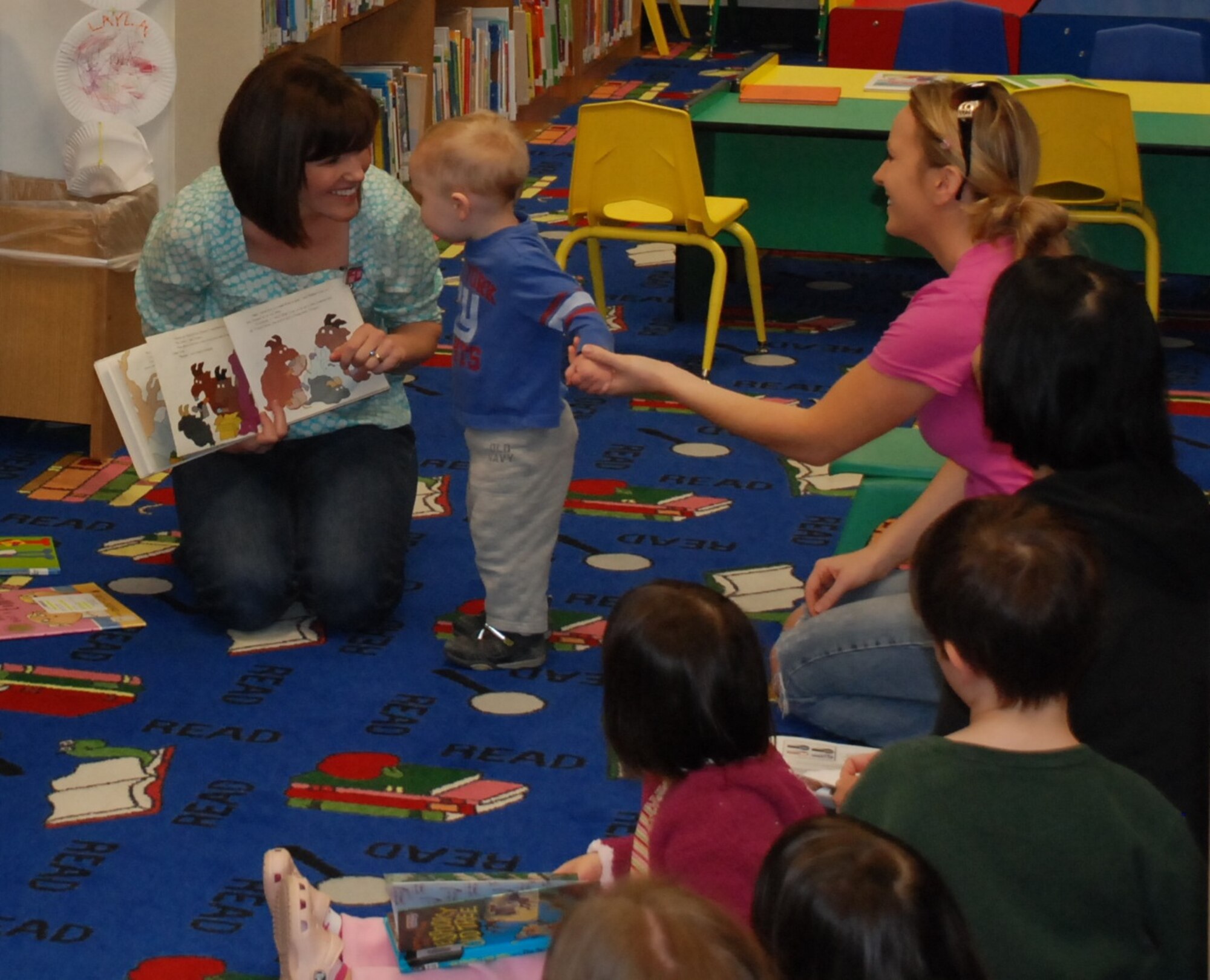 LAUGHLIN AIR FORCE BASE, Texas – Stacee Smith, Laughlin’s Health and Wellness Center dietician, reads a nutrition-themed book to a group of children and their parents at Laughlin’s library March 12 in recognition of National Nutrition Month. Various events are scheduled to be held throughout March to promote nutrition, including a cooking demonstration at Laughlin’s HAWC March 16. (U.S. Air Force photo by Airman 1st Class Blake Mize)