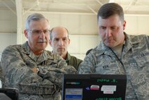 During a visit to the 940th Wing, Maj. Gen. Martin Mazick, Vice Commander of Air Force Reserve Command, observes a diagnostic check on the RQ-4 systems conducted by Tech. Sgt. Thomas Kirk, 13th Reconnaissance Squadron avionics technician, as Colonel Jeffrey Mineo, 940th Wing Commander, looks on.  General Mazick visited Beale Air Force Base, Calif., home of the RQ-4 Global Hawk, on March 10, 2010. 