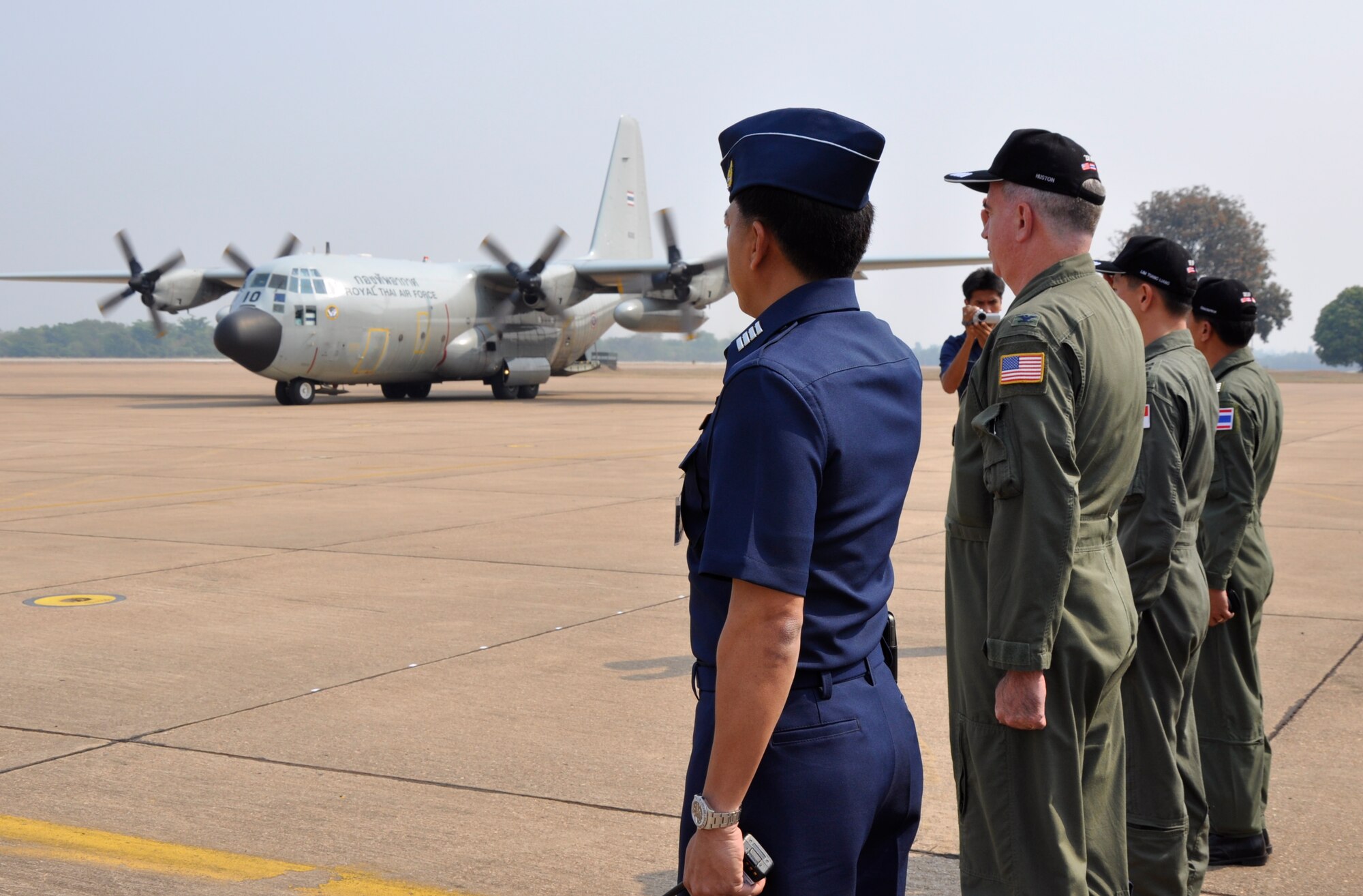 The U.S., Singaporean and Thai exercise directors for Cope Tiger 2010 render salutes as the official party arrives in a Royal Thai Air Force C-130 Hercules March 12 at Korat Royal Thai Air Force Base, Thailand. Cope Tiger is an annual multilateral exercise that enhances combined readiness and interoperability, and demonstrates U.S. commitment to the Asia-Pacific region. (U.S. Air Force photo/Capt. Christy Stravolo)
