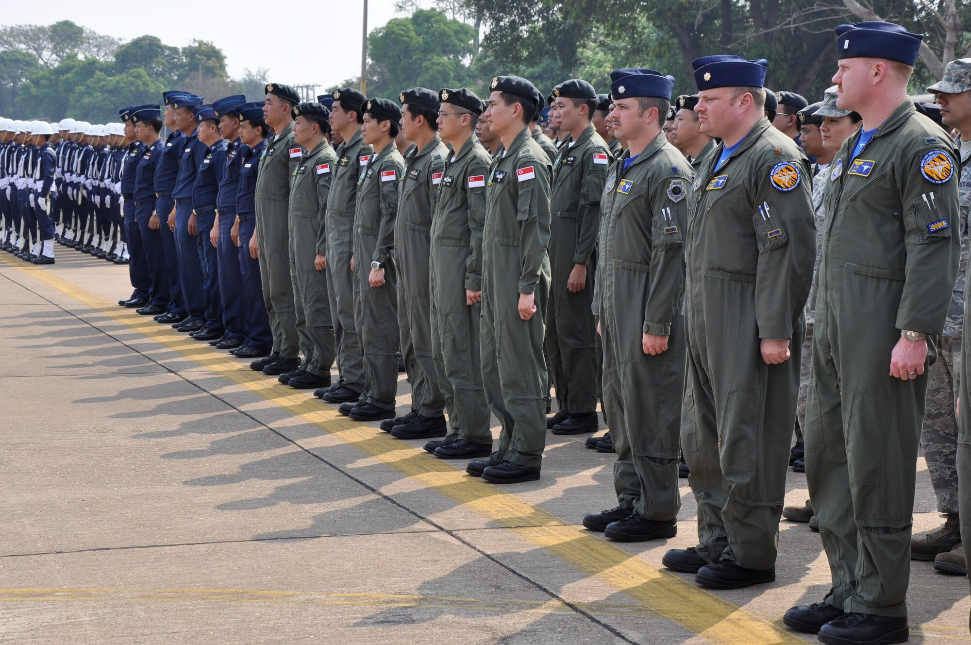 U.S., Singaporean and Thai military personnel participating in Cope Tiger 2010 await the arrival of the official party on the last day of the exercise at Korat Royal Thai Air Force Base, Thailand, March 12. Cope Tiger is an annual multilateral exercise involving aviation and ground units from the U.S. Air Force, the Royal Thai Air Force and Army, and the Republic of Singapore Air Force. (U.S. Air Force photo/Capt. Christy Stravolo)