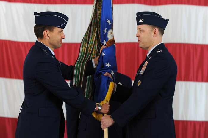 NELLIS AIR FORCE BASE, Nev --   Col. Steve Garland receives the guidon, symbolizing the acceptance of command, from Maj. Gen. Stanley T. Kresge, U.S. Air Force Warfare Center commander,  during the 99th Air Base Wing change of command ceremony held at the Thunderbird hangar March 12. (U.S. Air Force photo by Tech. Sgt. Michael R. Holzworth)

